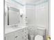 Beautiful bathroom featuring wainscoting, elegant vanity, and a toilet at 2196 Muskogee Trl, Nokomis, FL 34275