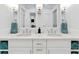 Bathroom featuring double sinks, white cabinetry, and modern finishes at 2196 Muskogee Trl, Nokomis, FL 34275