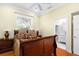 Bedroom with hardwood floors, a ceiling fan, and an ensuite bathroom at 2196 Muskogee Trl, Nokomis, FL 34275
