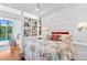 Bright bedroom with built-in shelving and seating overlooking the pool at 2196 Muskogee Trl, Nokomis, FL 34275