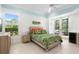 Bright bedroom with a floral bedspread, access to the outdoor patio, and plenty of natural light at 2196 Muskogee Trl, Nokomis, FL 34275