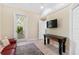 Bonus room offering access to the outdoor patio, a mounted TV, and seating at 2196 Muskogee Trl, Nokomis, FL 34275