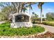 An attractive neighborhood entry sign identifying 'Calusa Lakes' amid lush greenery and a cascading water feature at 2196 Muskogee Trl, Nokomis, FL 34275