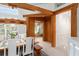 The dining room showcases exposed wood beams, a wooden table, and an adjacent entry/sun room at 2196 Muskogee Trl, Nokomis, FL 34275