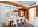 Dining room boasting wood beams, custom lighting, a wine room, and an abundance of natural light at 2196 Muskogee Trl, Nokomis, FL 34275