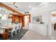 Open dining room featuring exposed wood beams, custom light fixtures, and shuttered windows at 2196 Muskogee Trl, Nokomis, FL 34275