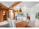 View of dining room with wood beams, chandelier, wine room, and white shuttered windows at 2196 Muskogee Trl, Nokomis, FL 34275