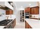 Well-equipped kitchen with stainless steel appliances, custom wood cabinetry, and a walk-in pantry at 2196 Muskogee Trl, Nokomis, FL 34275