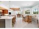 Spacious kitchen features a large center island, breakfast nook, and white tile flooring at 2196 Muskogee Trl, Nokomis, FL 34275