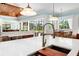 Spacious kitchen with white countertops and stainless steel appliances, view to the living room at 2196 Muskogee Trl, Nokomis, FL 34275