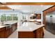 The kitchen features a center island, stainless appliances, and breakfast nook seating at 2196 Muskogee Trl, Nokomis, FL 34275