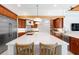 Modern kitchen features a large white quartz island with seating, stainless steel appliances, and custom cabinetry at 2196 Muskogee Trl, Nokomis, FL 34275