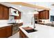 Kitchen features a large center island, stainless appliances, and sleek cabinetry at 2196 Muskogee Trl, Nokomis, FL 34275