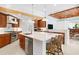 Gourmet kitchen boasts stainless appliances, a large island, and wood beam accents at 2196 Muskogee Trl, Nokomis, FL 34275