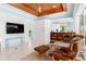 Comfortable living room with a wood-paneled ceiling, leather recliners, and views of the backyard at 2196 Muskogee Trl, Nokomis, FL 34275