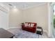 Bright living room featuring a red sofa, stylish rug, ceiling fan, and recessed lighting at 2196 Muskogee Trl, Nokomis, FL 34275