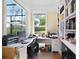 Well-lit home office featuring custom built-in shelving and large windows at 2196 Muskogee Trl, Nokomis, FL 34275