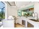 Outdoor kitchen with stainless steel grill and counter overlooking pool at 2196 Muskogee Trl, Nokomis, FL 34275