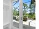 Outdoor patio view through doorway, with comfortable seating, landscaping, and golf course view at 2196 Muskogee Trl, Nokomis, FL 34275