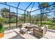 Spacious covered patio, offering views of the beautifully landscaped yard and outdoor seating at 2196 Muskogee Trl, Nokomis, FL 34275