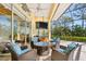 Covered outdoor patio with stylish seating, a ceiling fan, and views of lush landscaping at 2196 Muskogee Trl, Nokomis, FL 34275