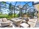 Enjoy outdoor living with a covered patio, complete with a fireplace and lush golf course views at 2196 Muskogee Trl, Nokomis, FL 34275