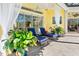 Cozy outdoor patio with lounge chairs, potted plants, and views of the pool and kitchen area at 2196 Muskogee Trl, Nokomis, FL 34275