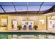 Covered patio with two lounge chairs and access to the house at 2196 Muskogee Trl, Nokomis, FL 34275