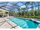 Screened-in pool with a spa, beautiful tiling, and plenty of outdoor space at 2196 Muskogee Trl, Nokomis, FL 34275
