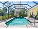 Screened-in pool with a spa, beautiful tiling, and plenty of outdoor space at 2196 Muskogee Trl, Nokomis, FL 34275