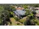 A serene backyard featuring a screened pool, complemented by lush landscaping and verdant surroundings at 2196 Muskogee Trl, Nokomis, FL 34275