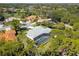 An aerial view of a home showcasing its screened pool and meticulously maintained landscaping amidst a lush, green environment at 2196 Muskogee Trl, Nokomis, FL 34275