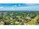 Expansive aerial view showcasing a neighborhood with mature trees and distant city skyline views at 2237 Lockwood Meadows Cir, Sarasota, FL 34234