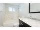 Bathroom features updated vanity with marble countertop, white tiled shower and window at 2237 Lockwood Meadows Cir, Sarasota, FL 34234