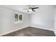 Bedroom with gray laminate flooring, a window with blinds, and modern ceiling fan at 2237 Lockwood Meadows Cir, Sarasota, FL 34234