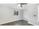 Bedroom features gray laminate flooring, window with blinds, and modern ceiling fan at 2237 Lockwood Meadows Cir, Sarasota, FL 34234