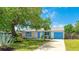 Cozy home featuring vibrant blue accents on the shutters and garage door, complemented by a lush green lawn at 2237 Lockwood Meadows Cir, Sarasota, FL 34234