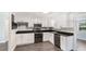 Modern kitchen featuring white cabinets, black countertops, and stainless steel appliances at 2237 Lockwood Meadows Cir, Sarasota, FL 34234