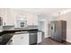 Well-appointed kitchen featuring white cabinets, stainless steel dishwasher, and modern appliances at 2237 Lockwood Meadows Cir, Sarasota, FL 34234