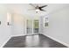 Living room offers modern ceiling fan, large sliding glass doors and gray laminate floors at 2237 Lockwood Meadows Cir, Sarasota, FL 34234