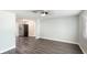 Bright living area featuring gray-toned flooring, neutral walls, and a modern ceiling fan at 2237 Lockwood Meadows Cir, Sarasota, FL 34234