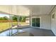 Enclosed porch looking out to a shed and fenced yard with a ceiling fan at 2237 Lockwood Meadows Cir, Sarasota, FL 34234