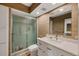 Bathroom featuring a glass-enclosed shower, white vanity, modern fixtures and neutral-toned walls at 225 Hourglass Way # 306, Sarasota, FL 34242