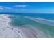 An aerial view of the beach shows the gulf coast shoreline with views of the sandy beach and ocean at 225 Hourglass Way # 306, Sarasota, FL 34242