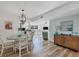 Dining area with wood floors, modern chandelier, seating for four and an open concept at 225 Hourglass Way # 306, Sarasota, FL 34242