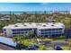 Lovely low-rise condo building featuring coastal views, mature palms and well-maintained landscaping at 225 Hourglass Way # 306, Sarasota, FL 34242