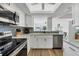 Bright kitchen with stainless appliances and breakfast bar opening up to the living area at 225 Hourglass Way # 306, Sarasota, FL 34242