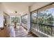 Bright sunroom featuring tile floor, large windows with beautiful treetop views at 225 Hourglass Way # 306, Sarasota, FL 34242