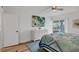 Cozy bedroom with a large dresser, sliding glass doors, and bright natural light at 225 Hourglass Way # 306, Sarasota, FL 34242
