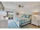 Bright main bedroom with ceiling fan and sliding glass doors that lead to balcony at 225 Hourglass Way # 306, Sarasota, FL 34242